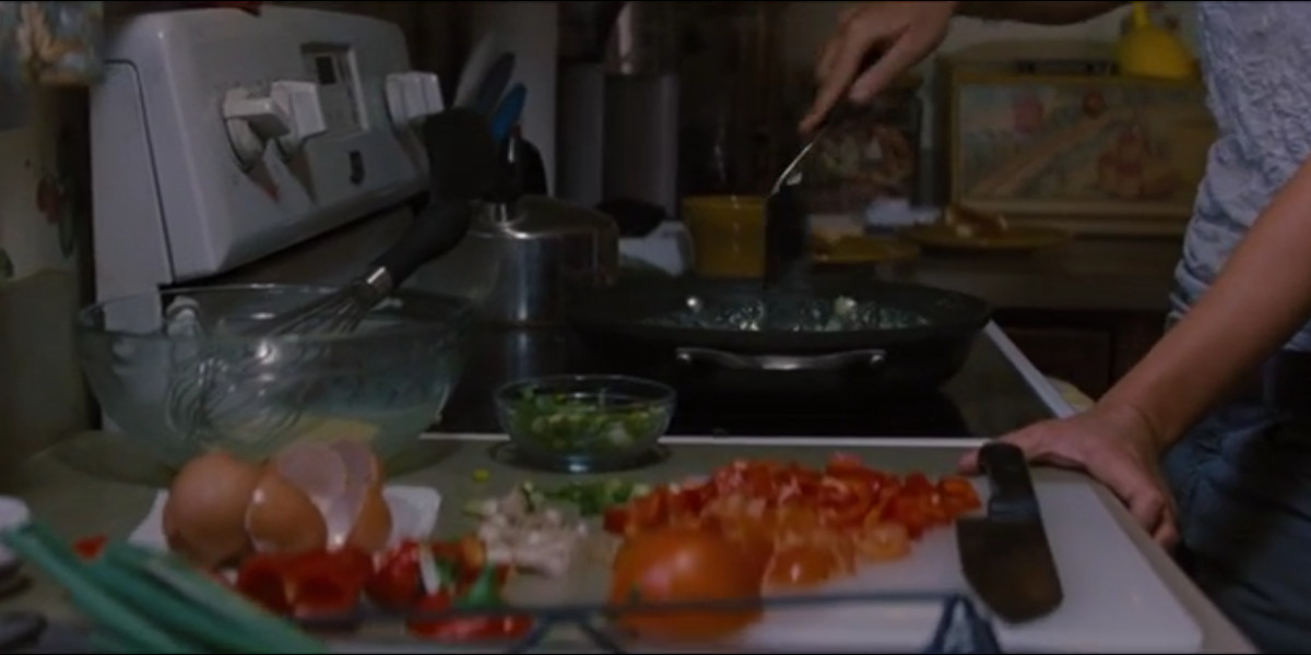 Sara cooks breakfast in Looper
