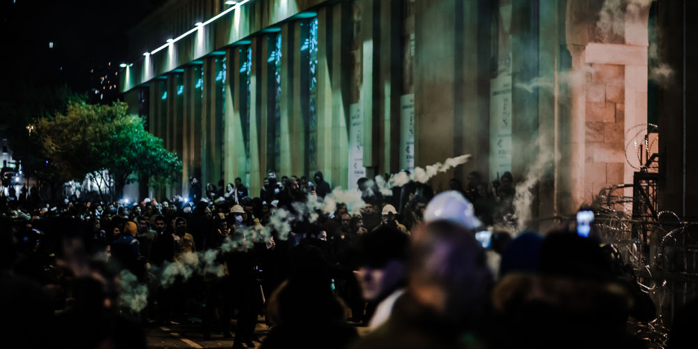 riot police battle protesters